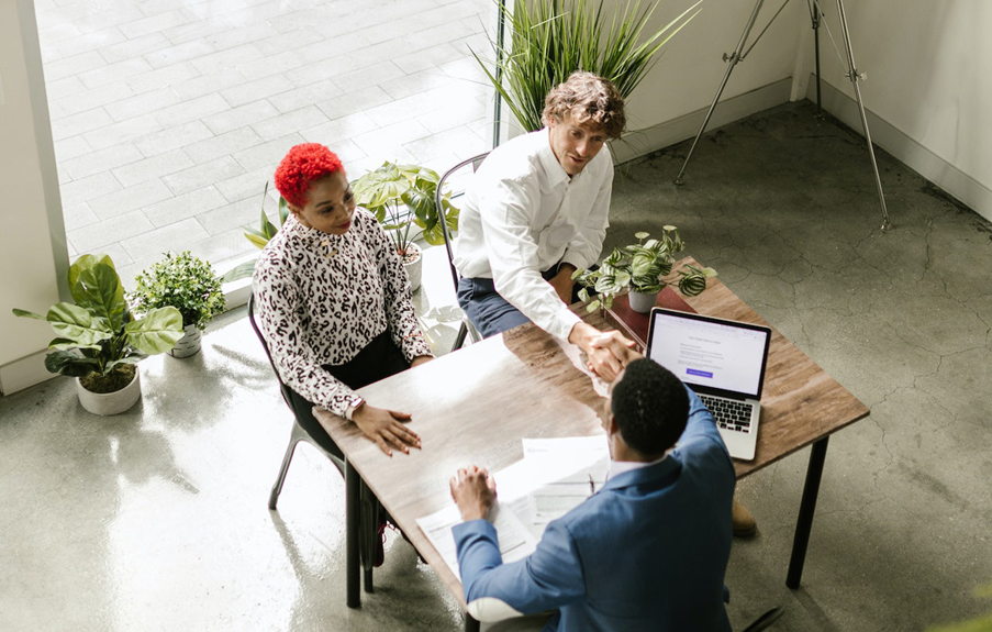 couple meeting with businessman at table