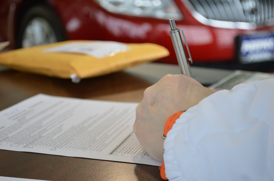 hand filling out mortgage form